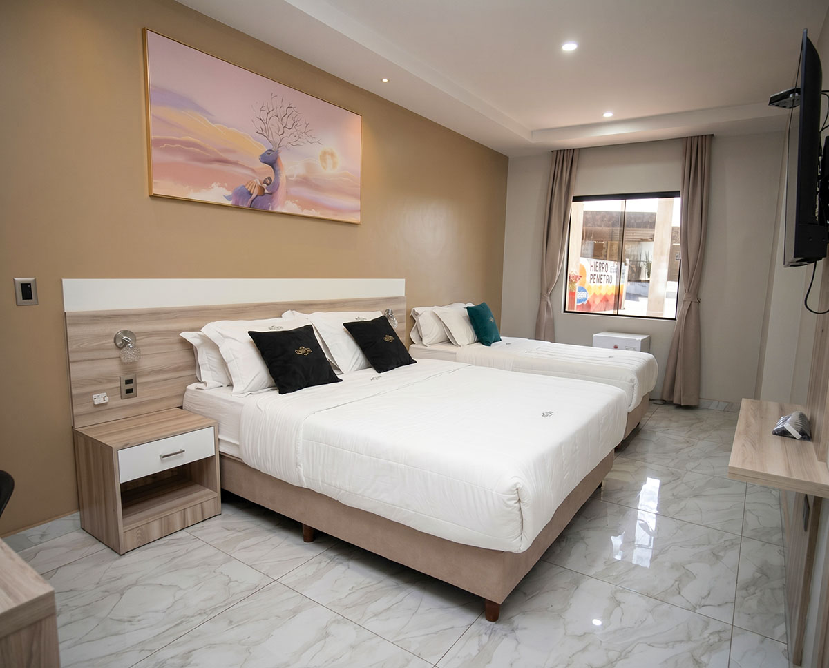Family double room at Los Olivos Hotel with a double bed and a single bed